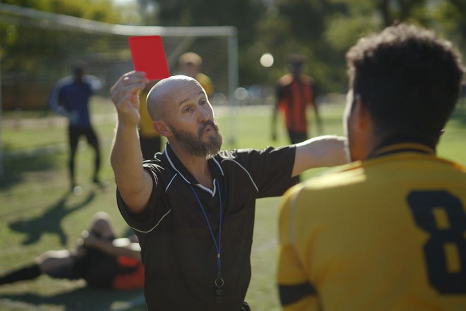 Referee holding a red card