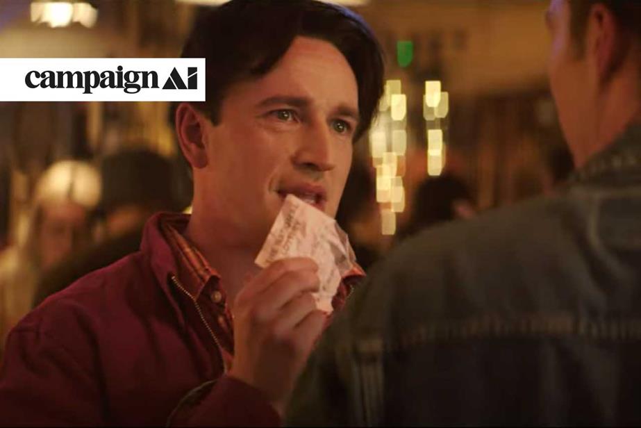 National Lottery ad in which a man is showing another a lottery ticket