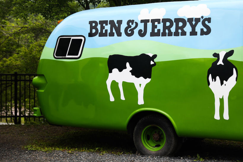 Ben & Jerry's branded bus displaying cow mascots