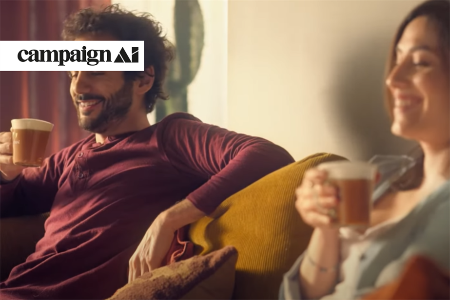 Nescafe ad where two people are sitting on a couch drinking coffee